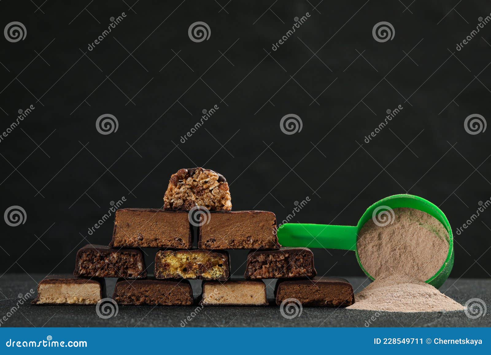 Different Tasty Energy Bars and Protein Powder on Grey Table, Space for