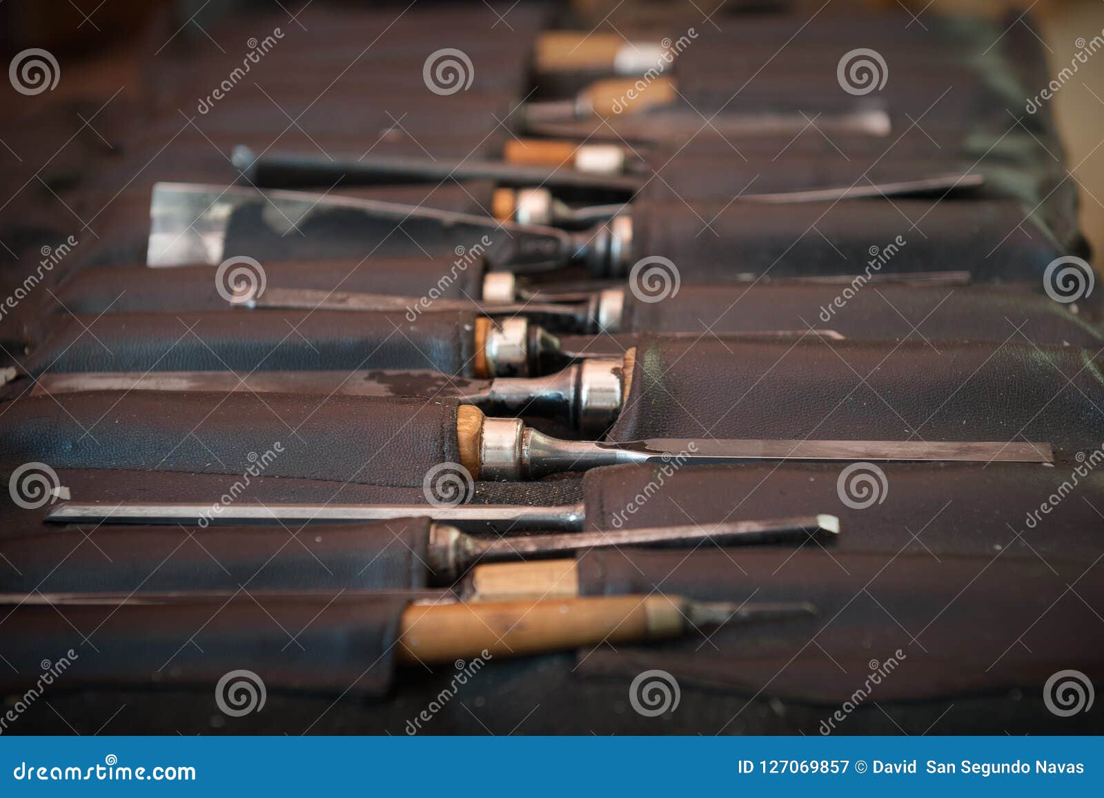 gouges and chisels in the foreground leather case