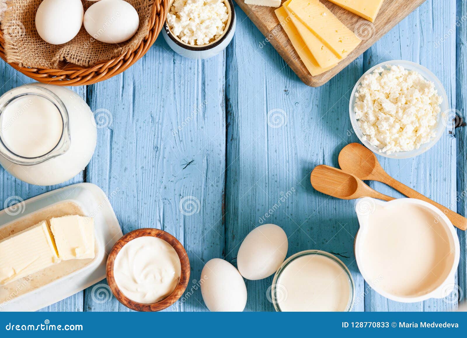 Different Types Of Dairy Products On Blue Wooden Background Mil