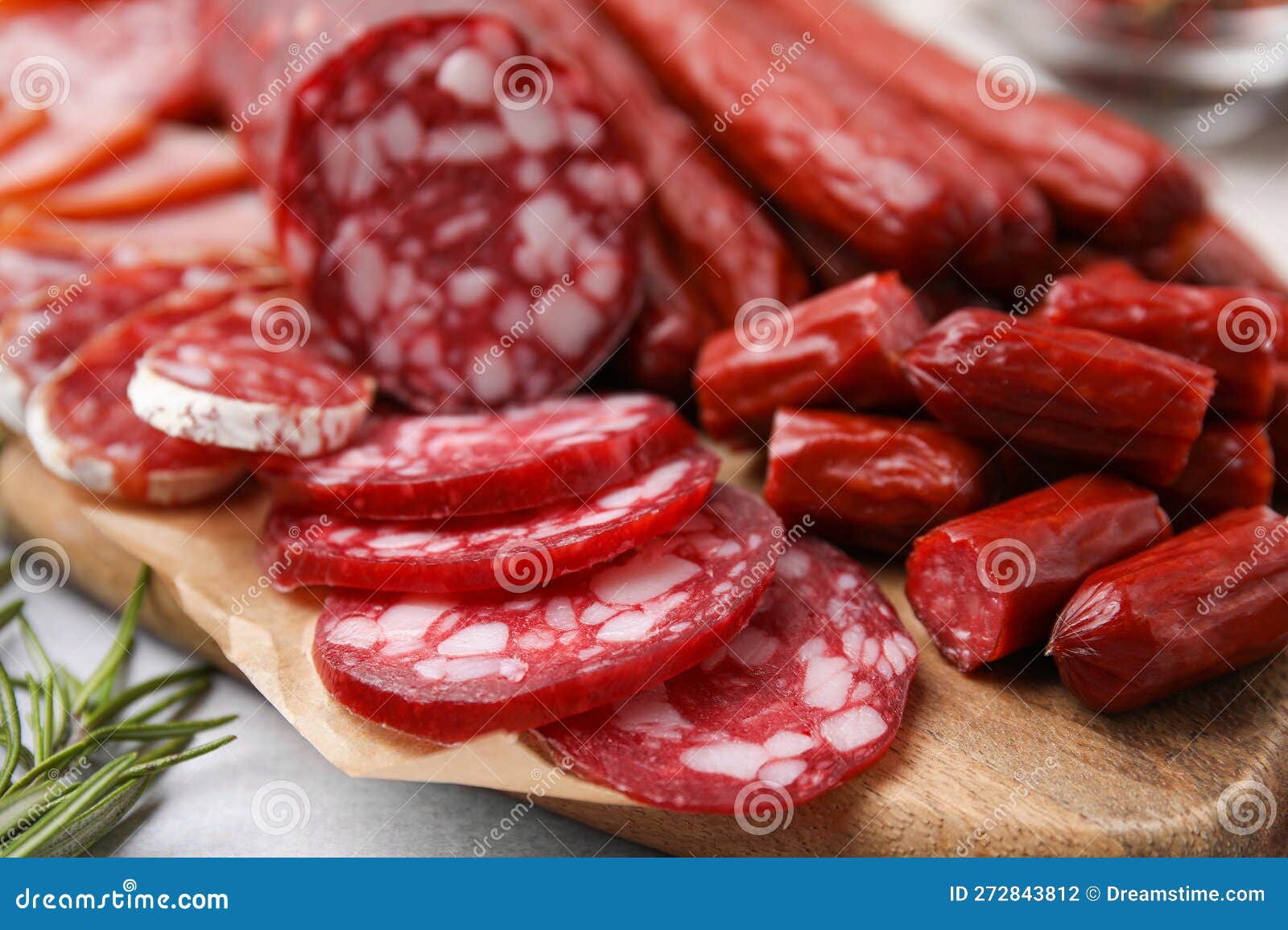 Different Types of Delicious Sausages on Light Grey Table, Closeup