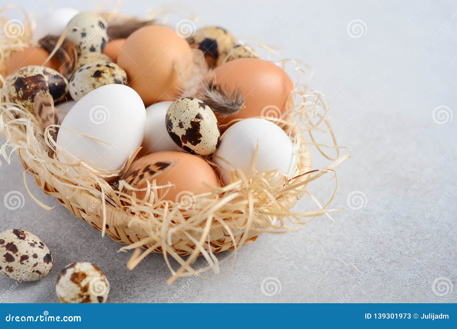 Different Types of Eggs in a Basket on a Gray Concrete Background