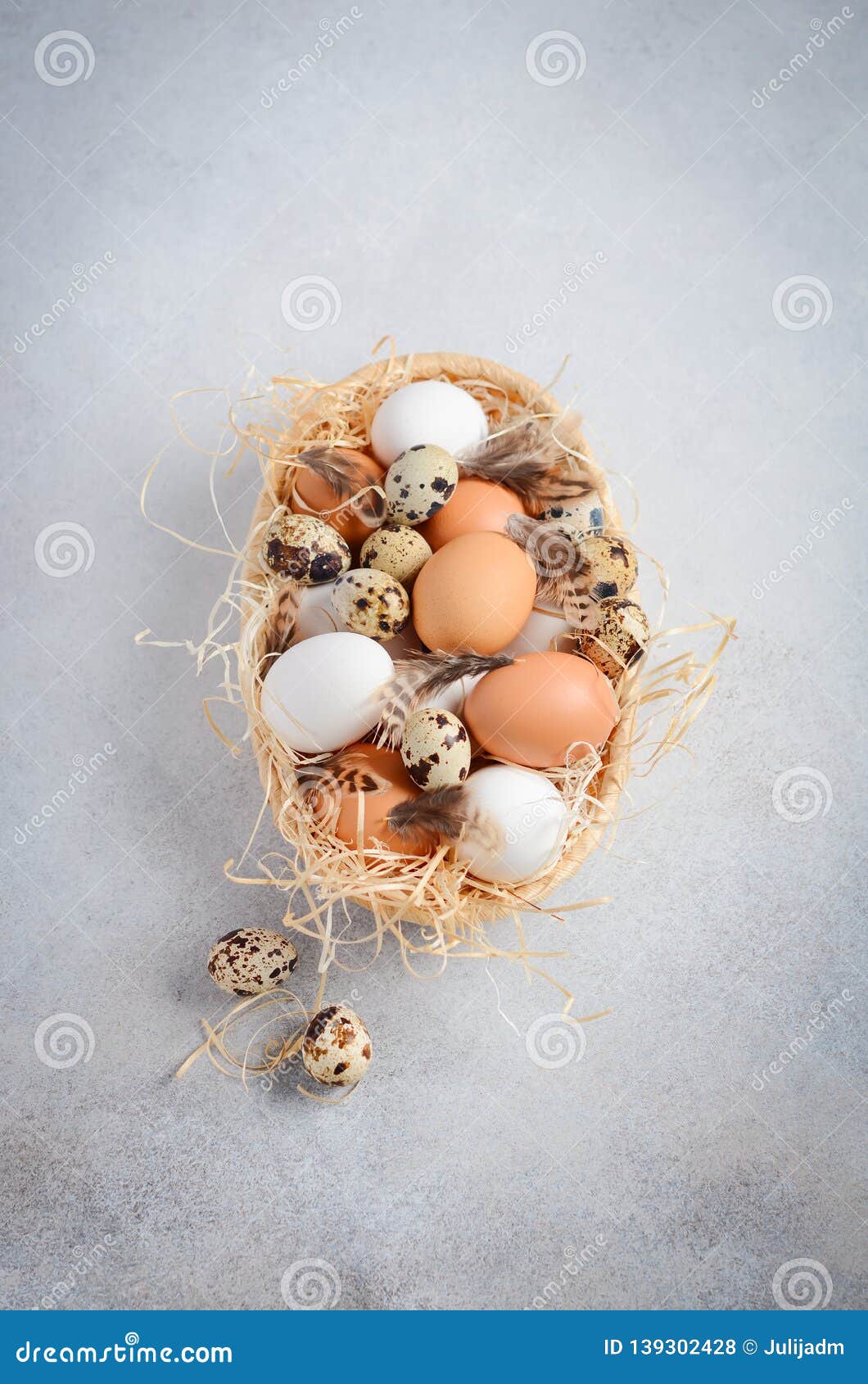 Different Types of Eggs in a Basket on a Gray Concrete Background