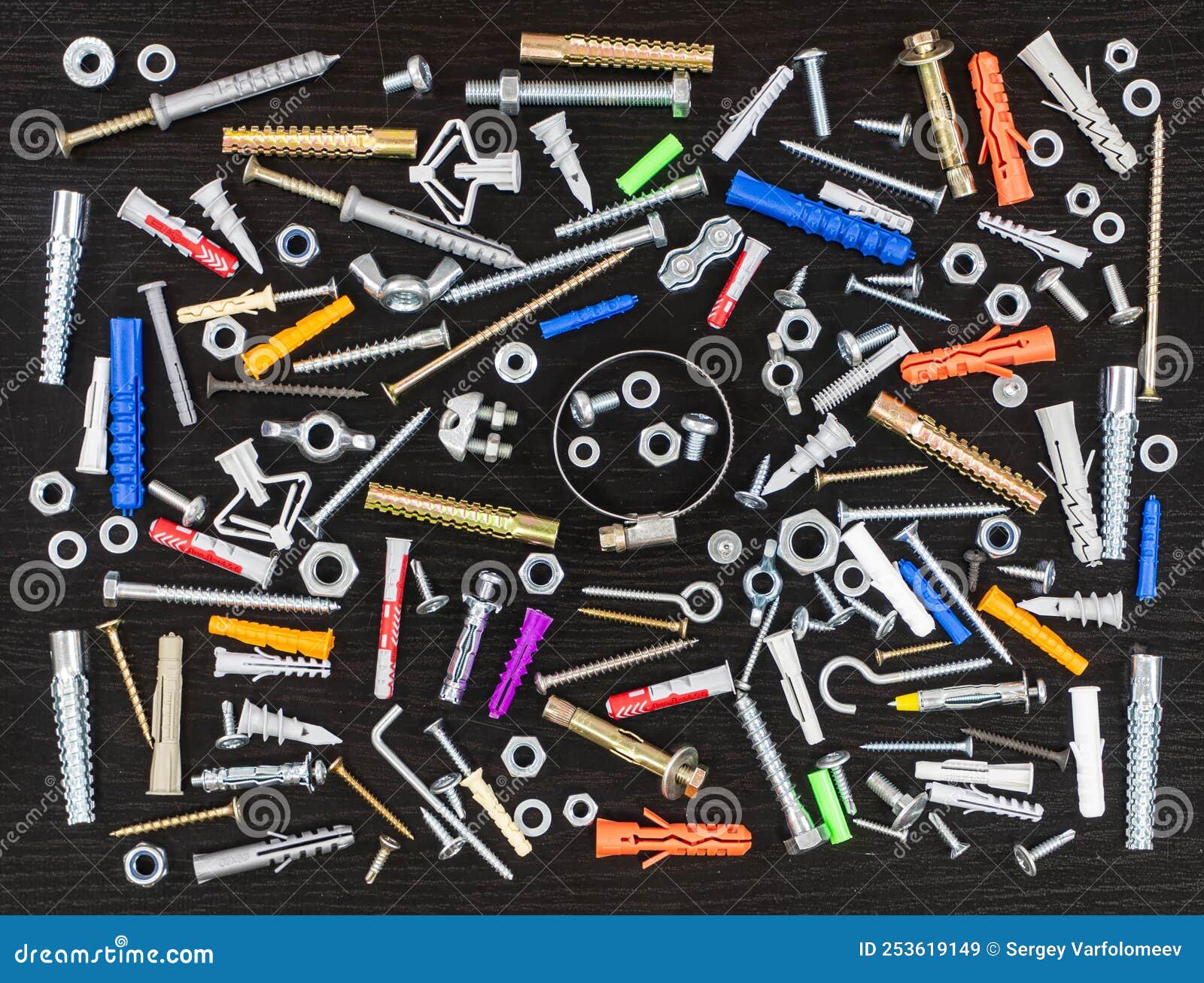 Different Types of Fasteners on a Dark Wood Background. Stock Image