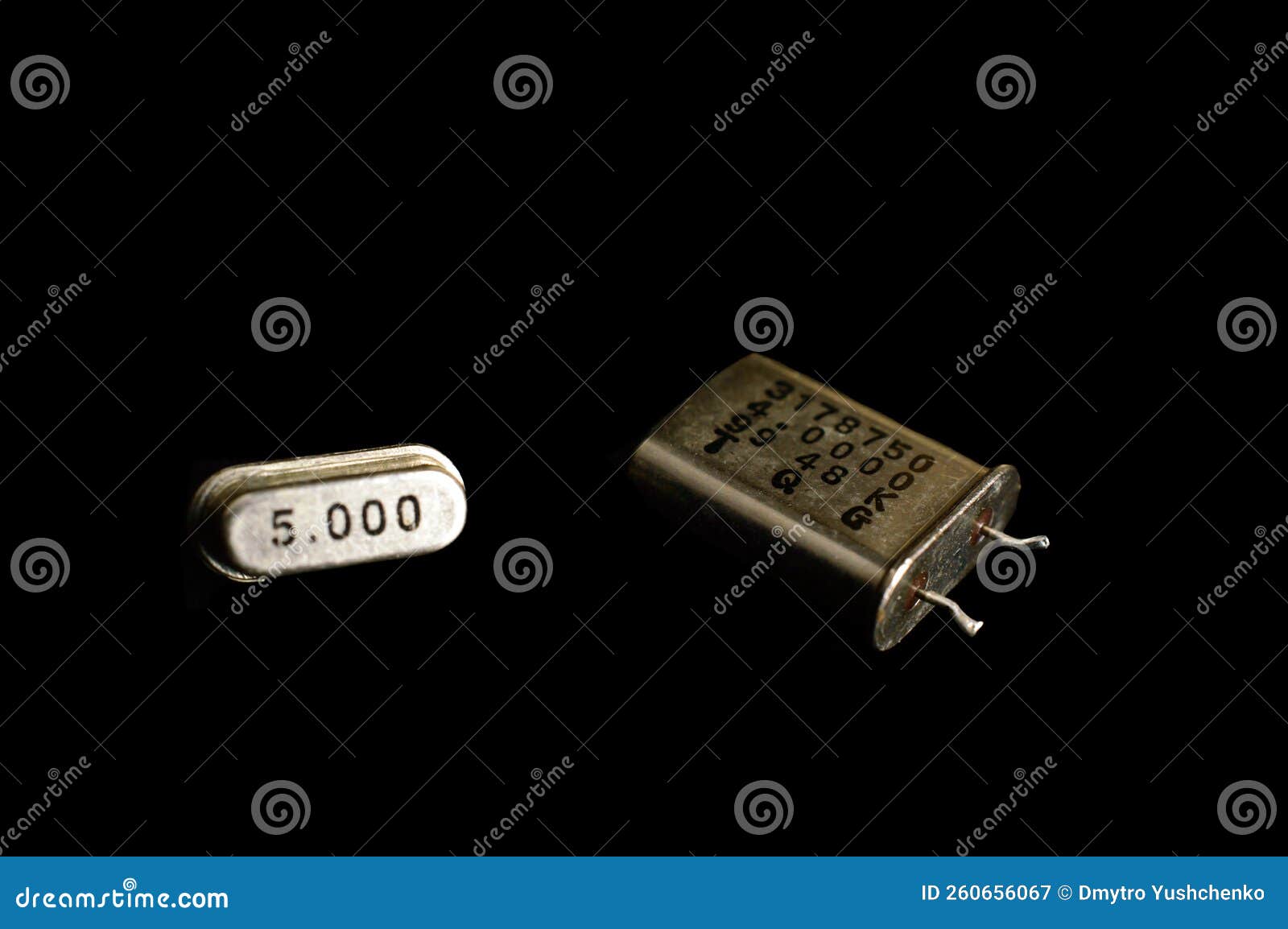 different types of quartz resonators.  on black background. electronic components.