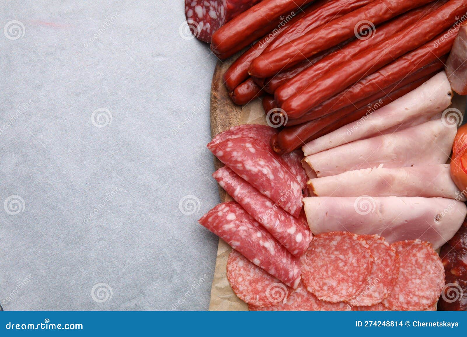 Different Types of Sausages on Light Grey Table, Flat Lay. Space for