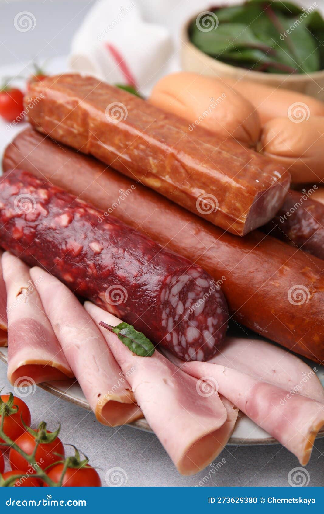 Different Types of Tasty Sausages and Ingredients on White Table