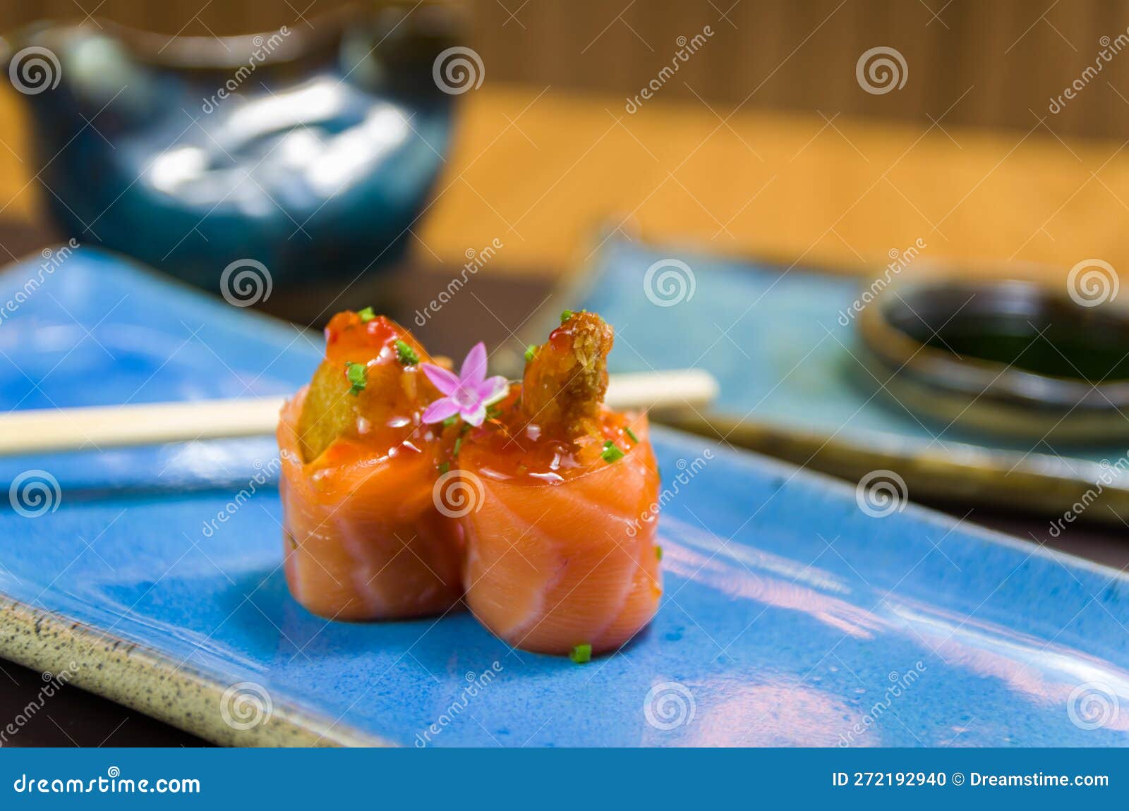 differents japanese sushi on a elegant blue plate