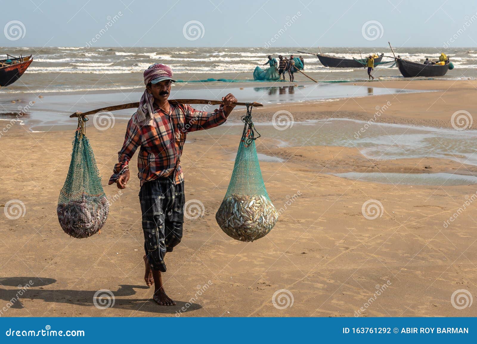 An Unidentified Fisherman Carrying Small Fishes Editorial