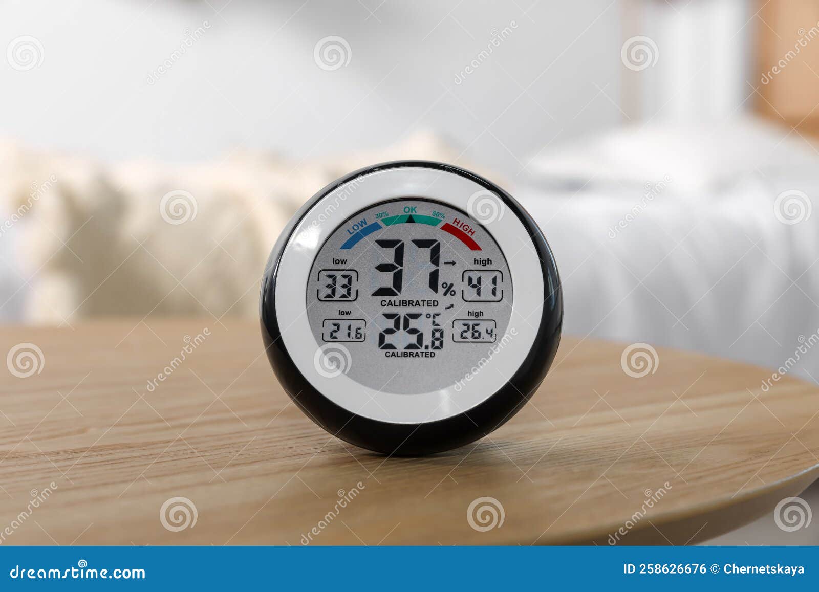 Digital Hygrometer with Thermometer on Wooden Table Indoors Stock Photo