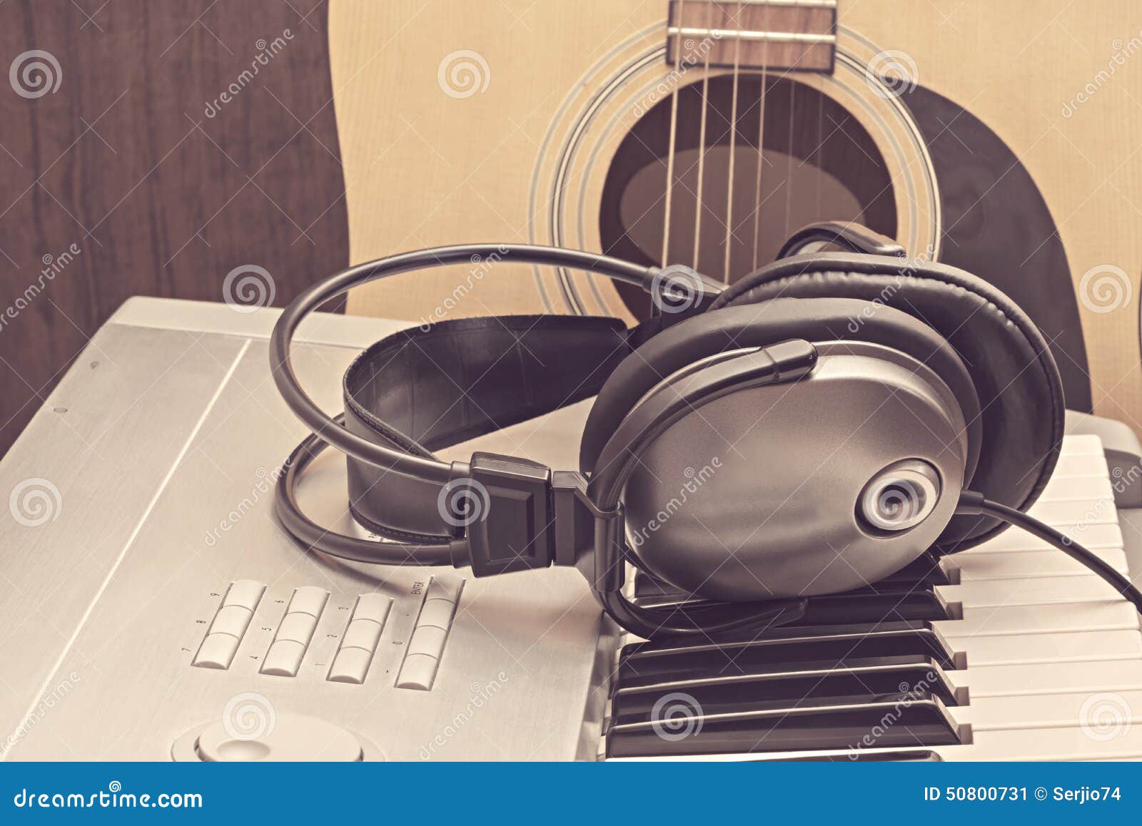Digital Midi Keyboard, Headphones and Acoustic Guitar. Stock Image