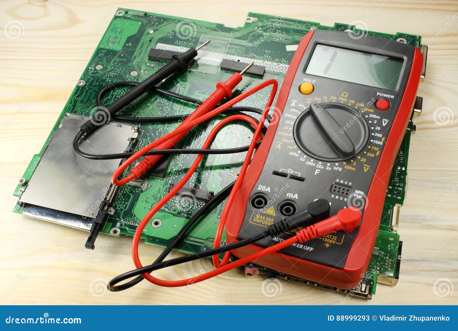 Digital Multimeter with Circuit Board on a Wooden Table Stock Image