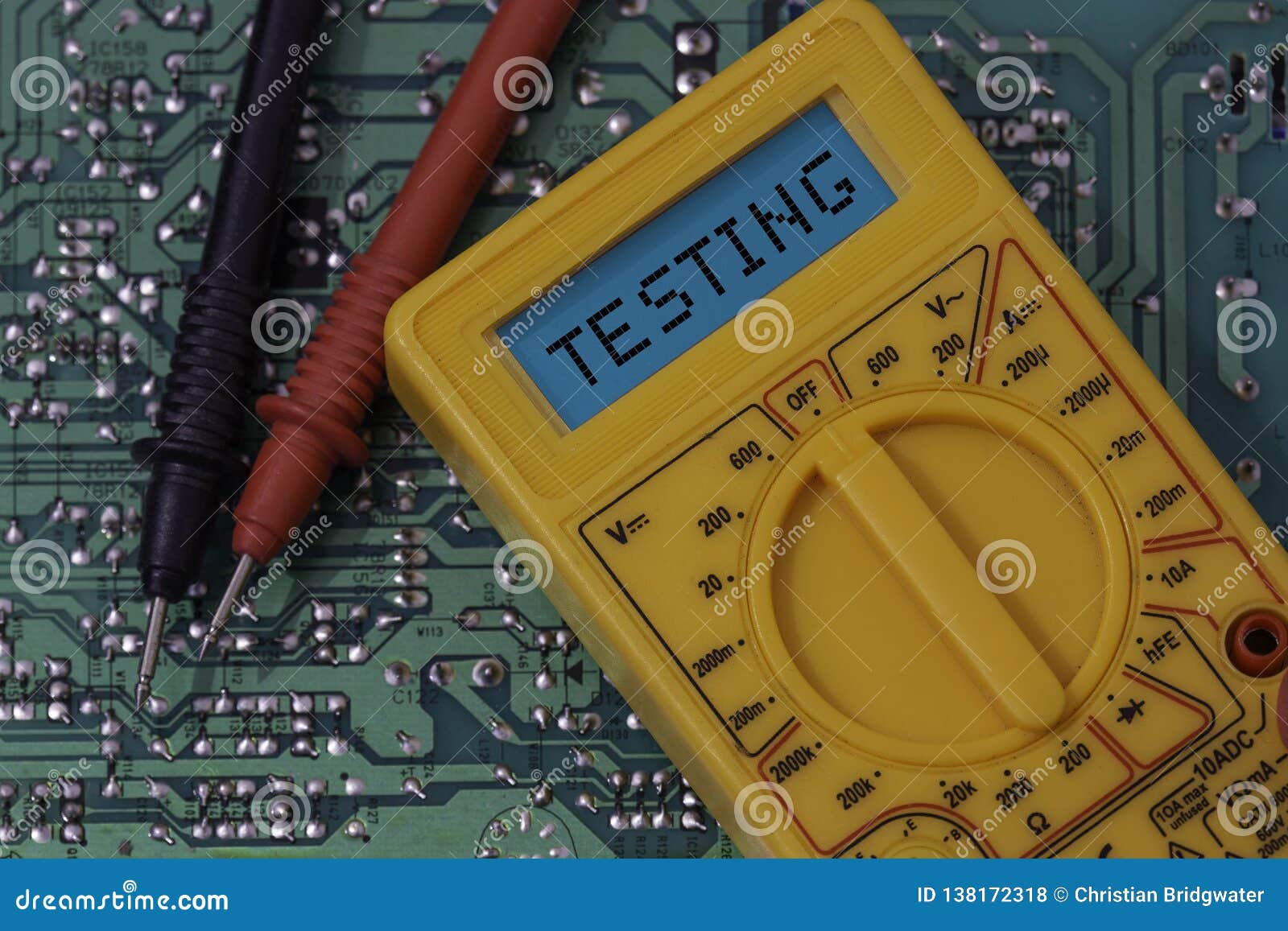 Digital Multimeter Multitester on a Circuit Board with the Word Testing