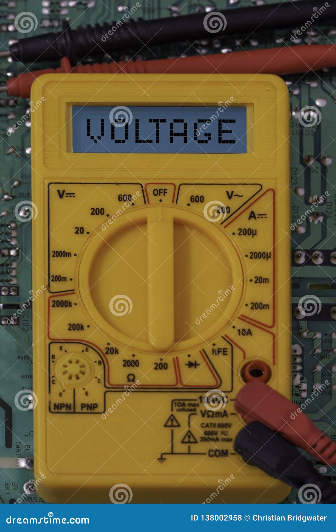 Digital Multimeter Multitester on a Circuit Board with the Word Voltage