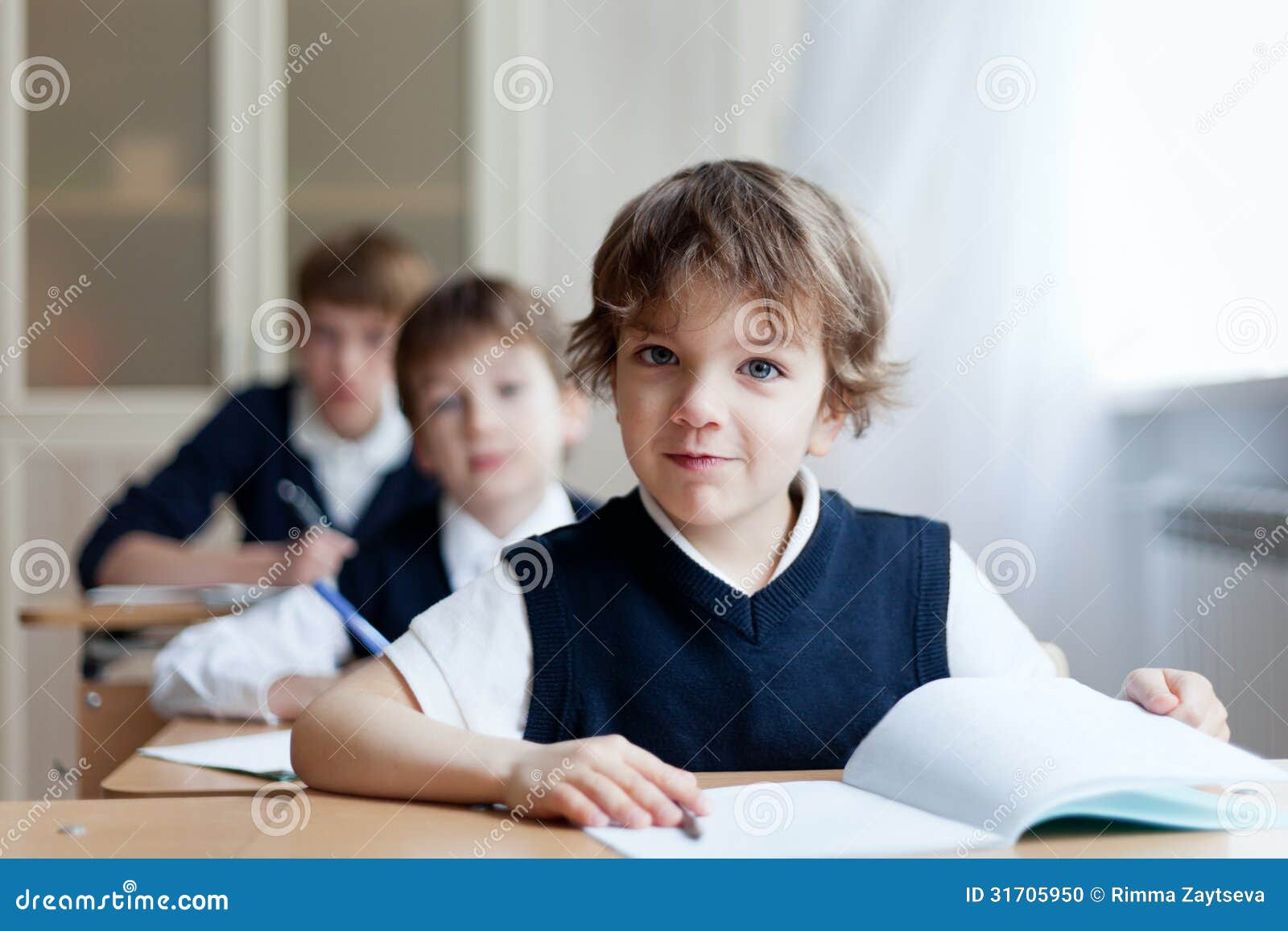 diligent student sitting at desk, classroom