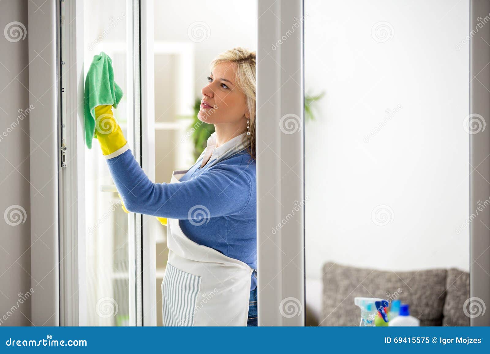 diligent woman cleans window