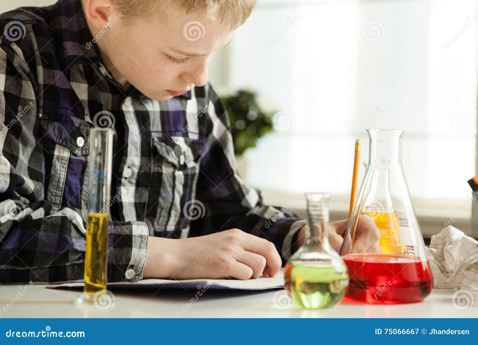 diligent young boy doing his science homework