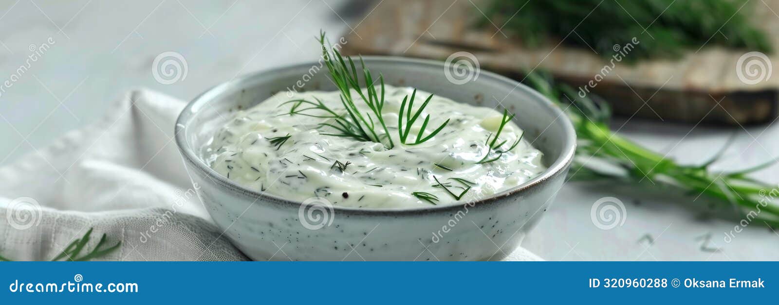 dill sauce in bowl, tzatziki greek dip, tarator, cacik or tartar with lemon, dill dressing, mayo, yogurt cream