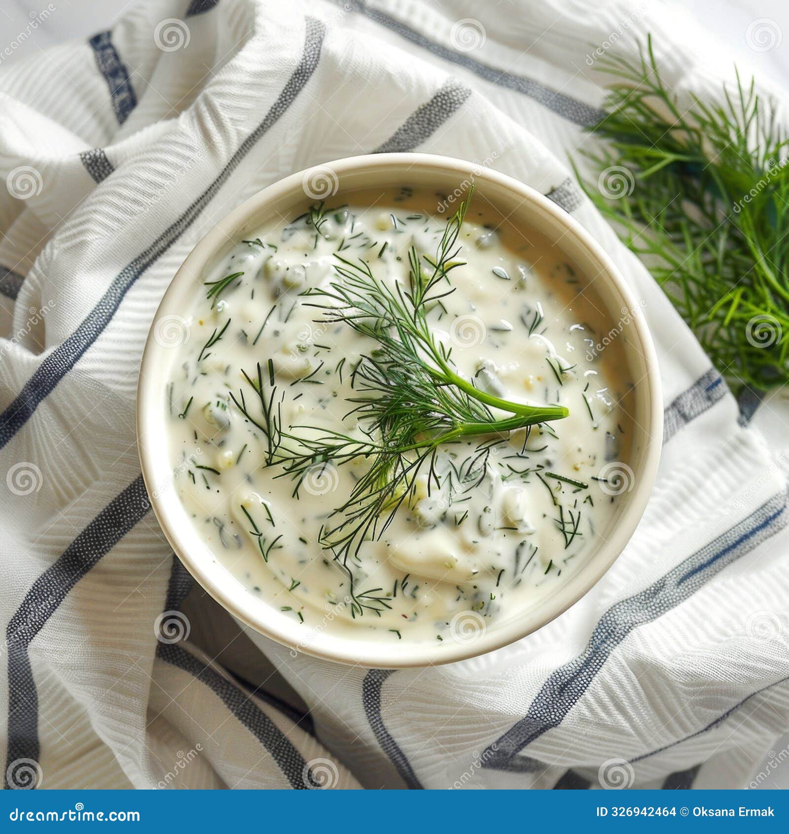 dill sauce in bowl, tzatziki greek dip, tarator, cacik or tartar with lemon, dill dressing, mayo, yogurt cream