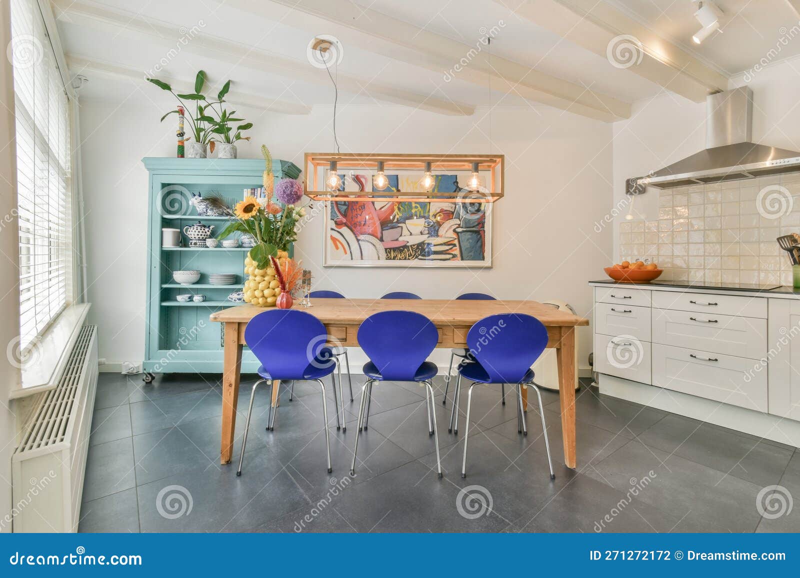 A Dining Room with a Wooden Table and Blue Chairs Editorial Photography