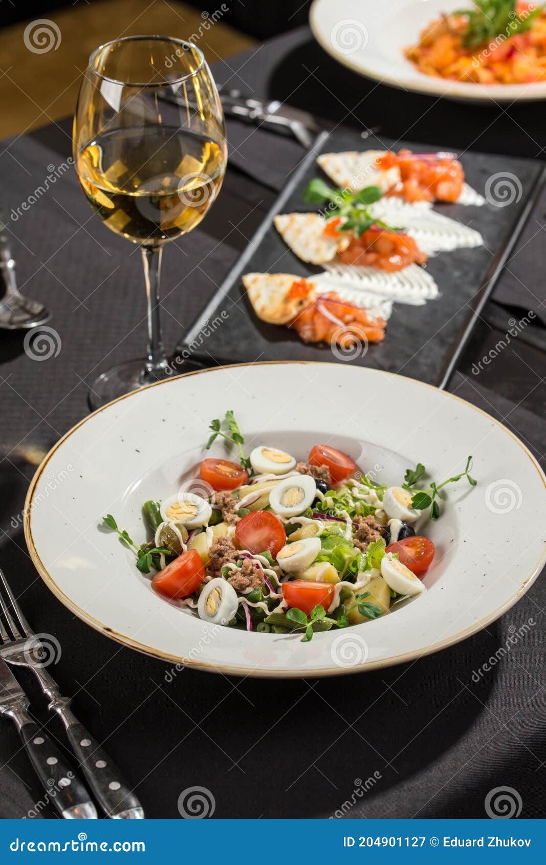 Dining Table Set with Appetizer and Drinks in Restaurant Stock Image