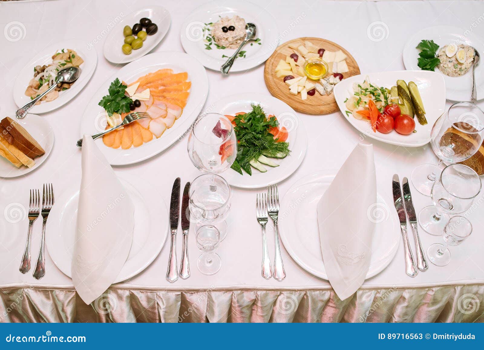 Dinner Table with Different Dishes and Empty Cutlery Stock Image