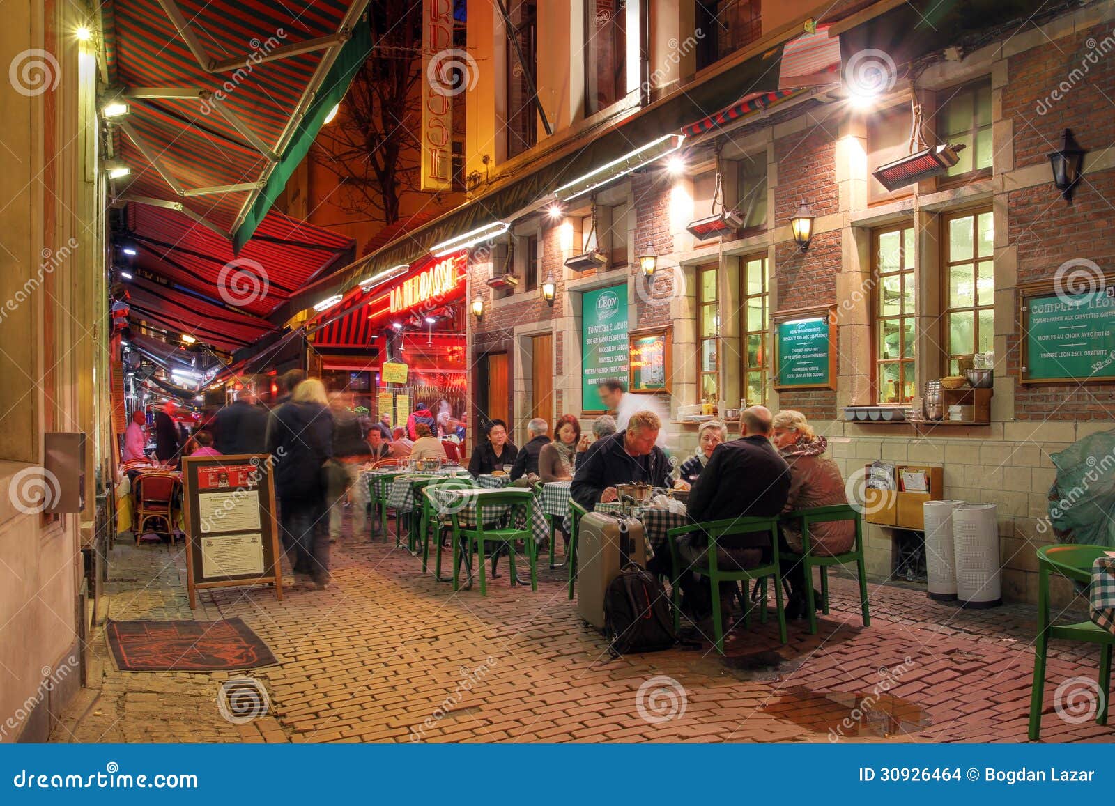 Dinning casuale a Bruxelles, Belgio. BRUXELLES - 22 APRILE: Dinning casuale su Rue de Bouchers a Bruxelles del centro, Belgio sul Aprill 22, 2012. Questa via pedonale è occupata principalmente dai ristoranti ed è più nota come la pancia di Bruxelles.