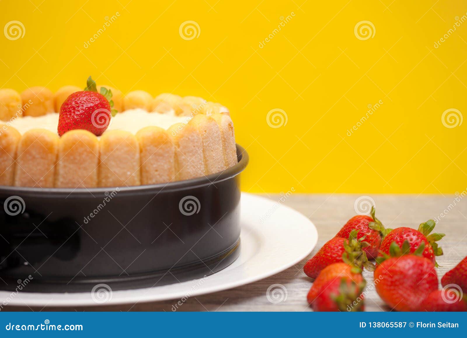 Diplomat Cake or Charlotte Cake with Strwaberries and Lady Fingers in Baking  Pan on a Wooden Table with Yellow Background / Focus Stock Image - Image of  food, background: 138065587