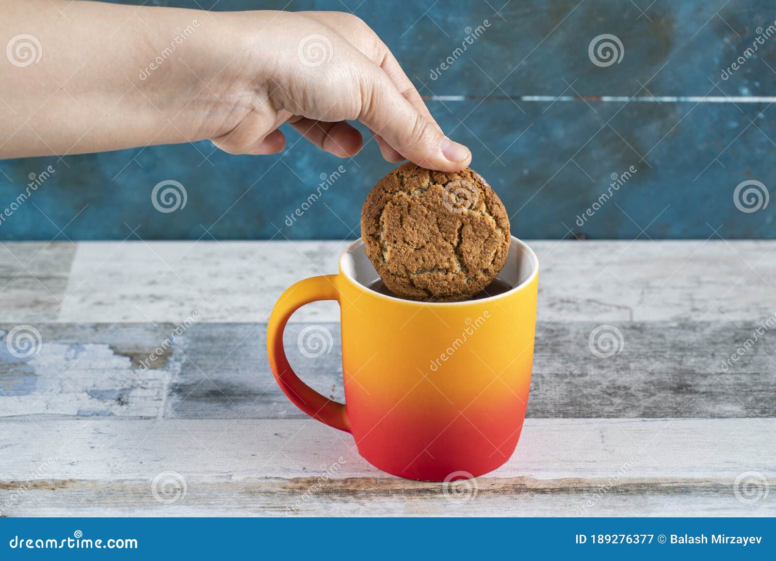 Dipping a cookie into tea stock image. Image of pastry 189276377