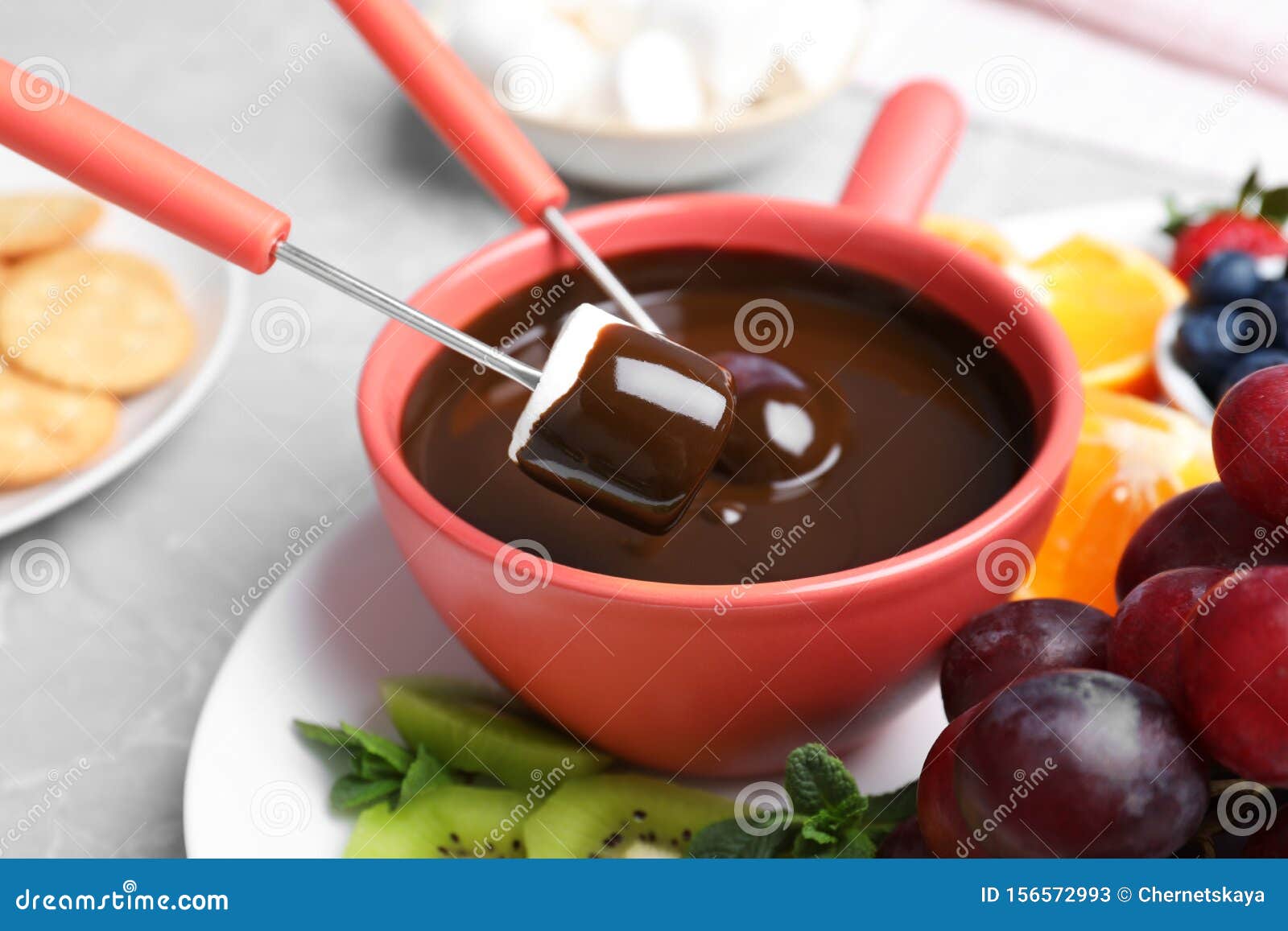 Dipping Marshmallow into Pot with Chocolate Fondue Stock Image Image
