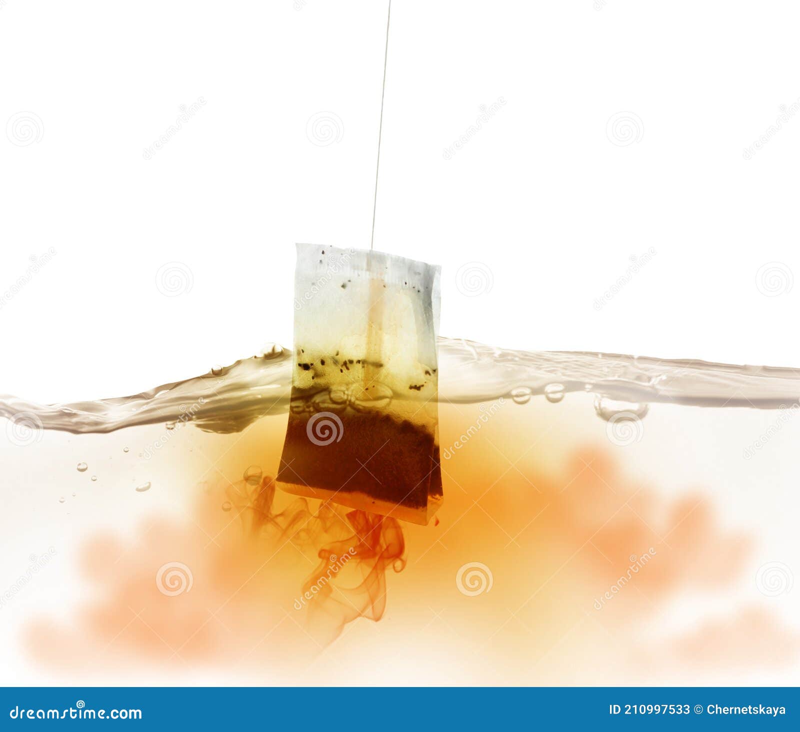 Dipping of Tea Bag into Hot Water Against White Background Stock Image