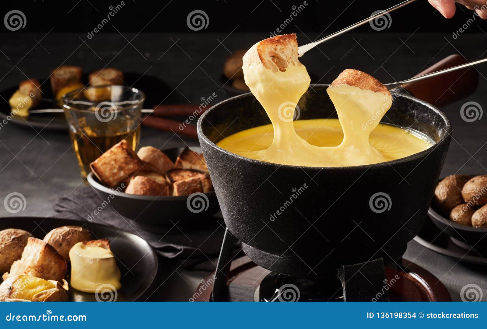 Dipping Toast in a Swiss Cheese Fondue Stock Photo - Image of fondue ...