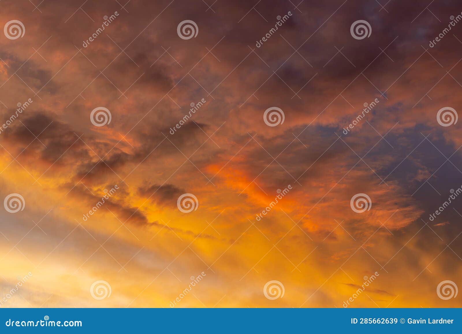 direct sunlight shining in under a layer of feathery clouds