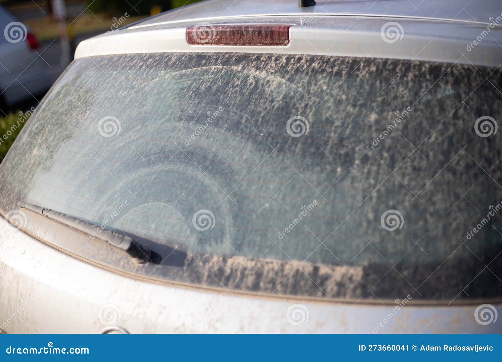 dirty back glass on car from unclean rain with sand