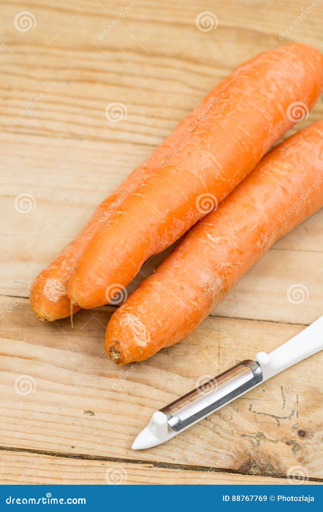 Dirty Carrots with Peeling Knife on the Wooden Table Stock Image