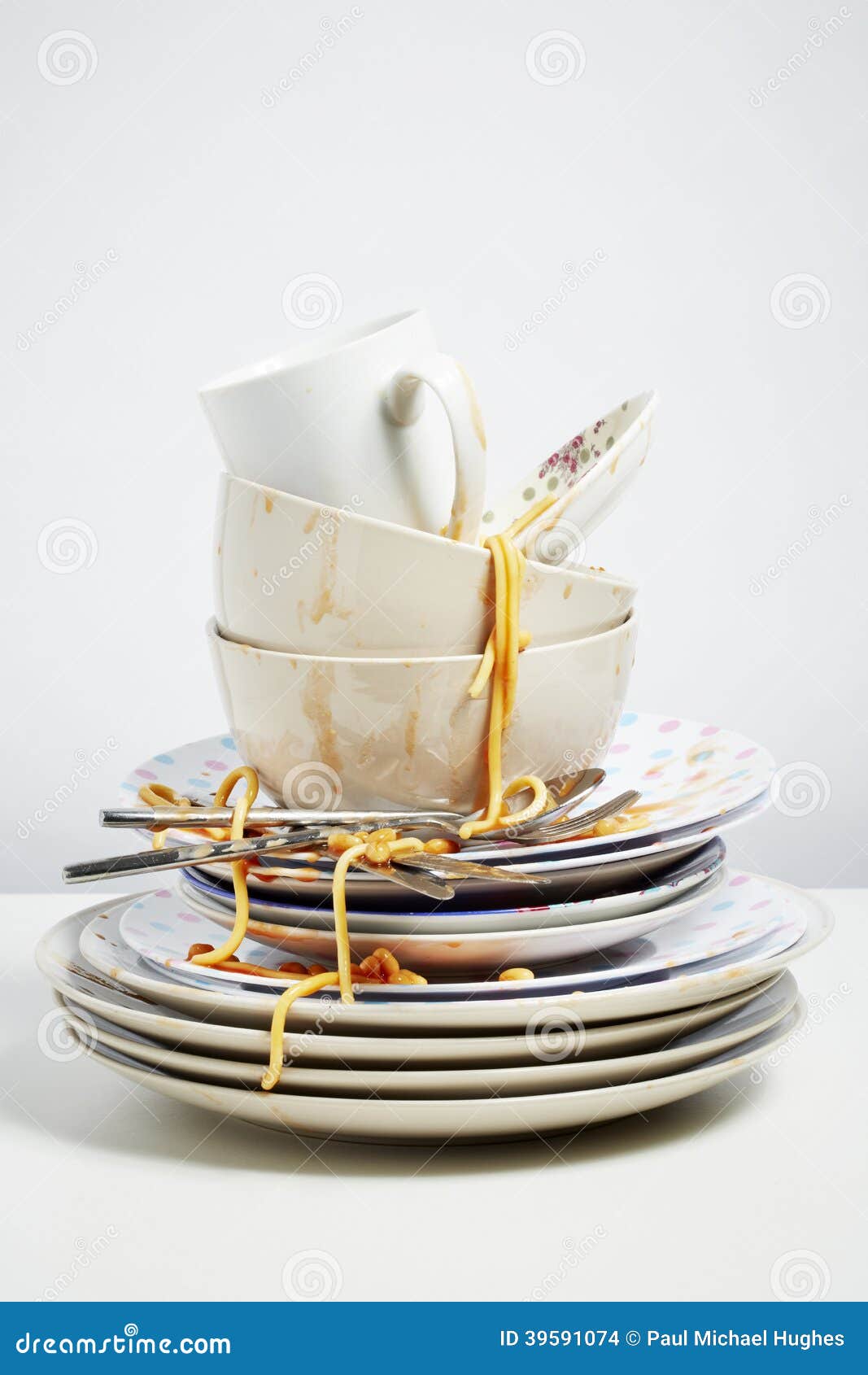 dirty dishes pile needing washing up on white background