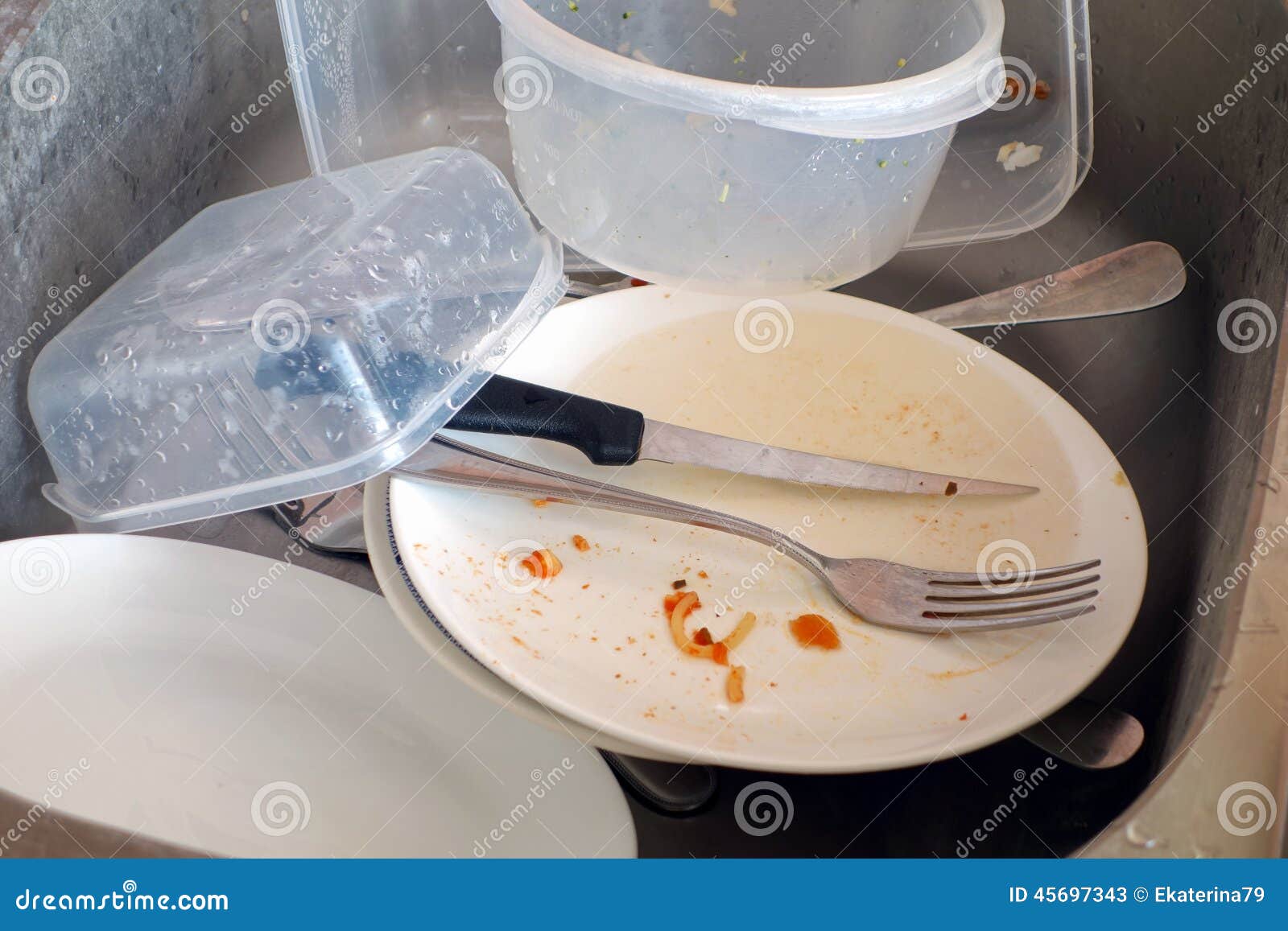 Dirty dishware in kitchen sink