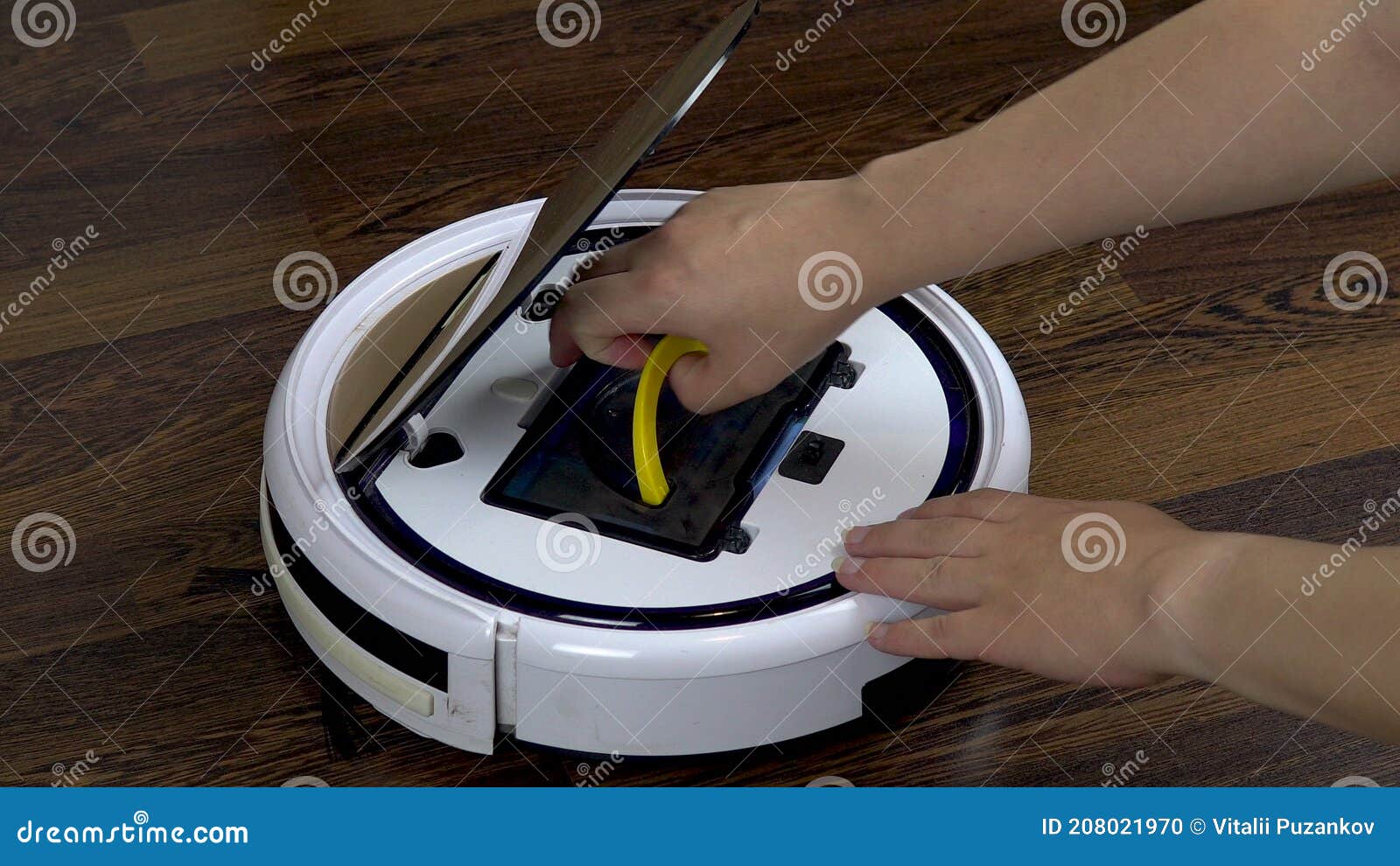A Dirty Filter is Pulled Out of a Vacuum Cleaner Robot. Automatic White