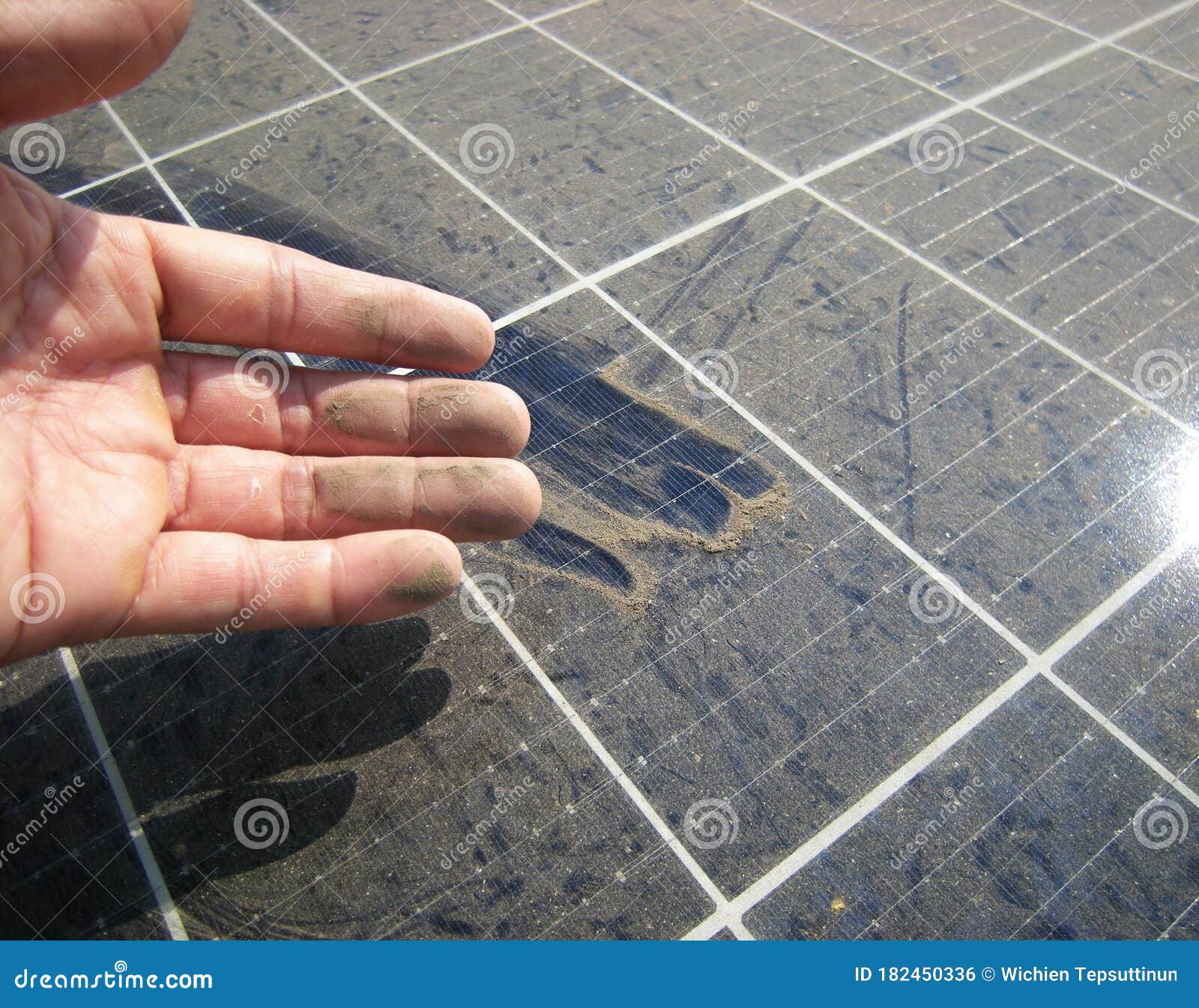 dirty hand after rubbing dusty solar panel