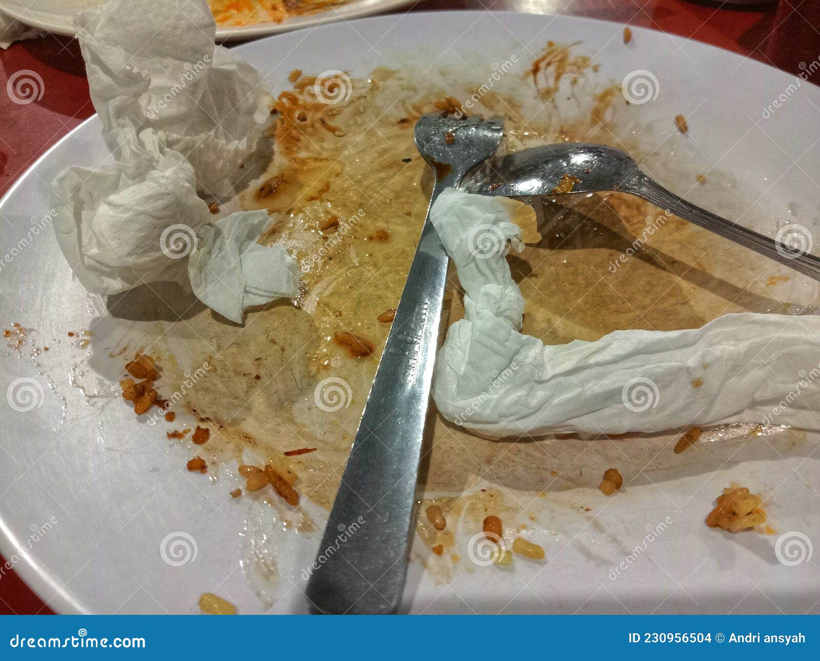 Dirty Plates, Spoons, Forks and Tissues on the Table Stock Photo