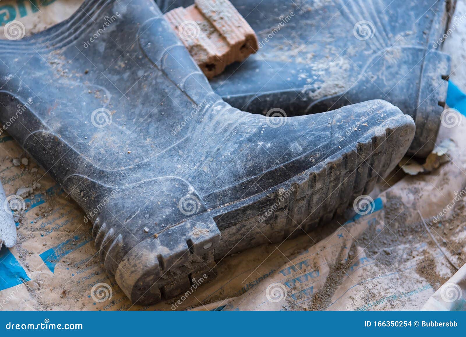 Dirty Rubber Boots of Workers in the Construction Site Stock Photo ...