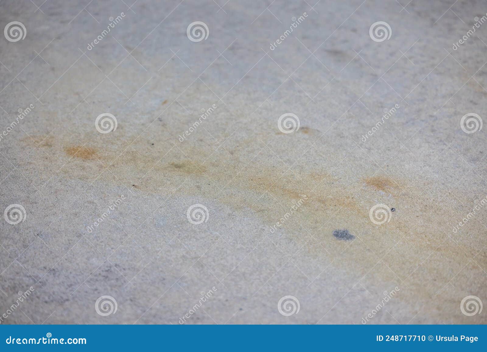 Dirty Rust and Dirt Stains on a Concrete Driveway or Sidewalk that
