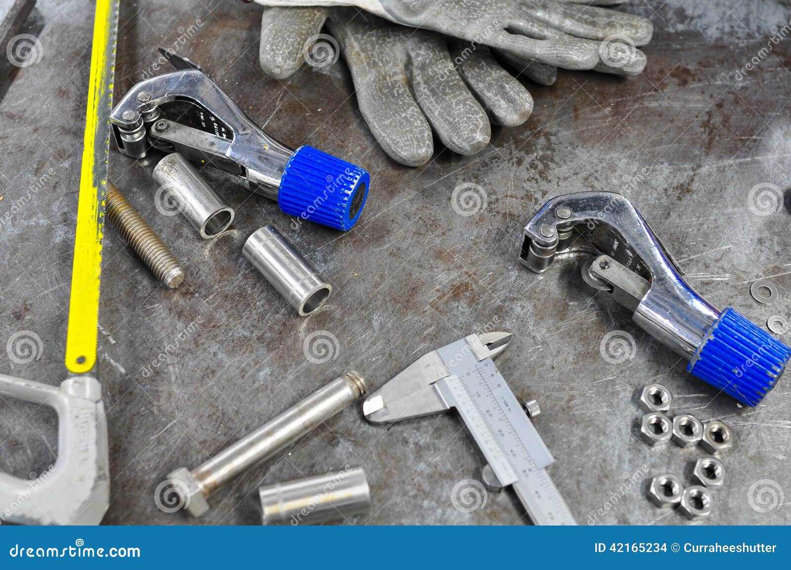 Dirty Set of Hand Tools on Table, Assorted Work Tools on Table. Stock