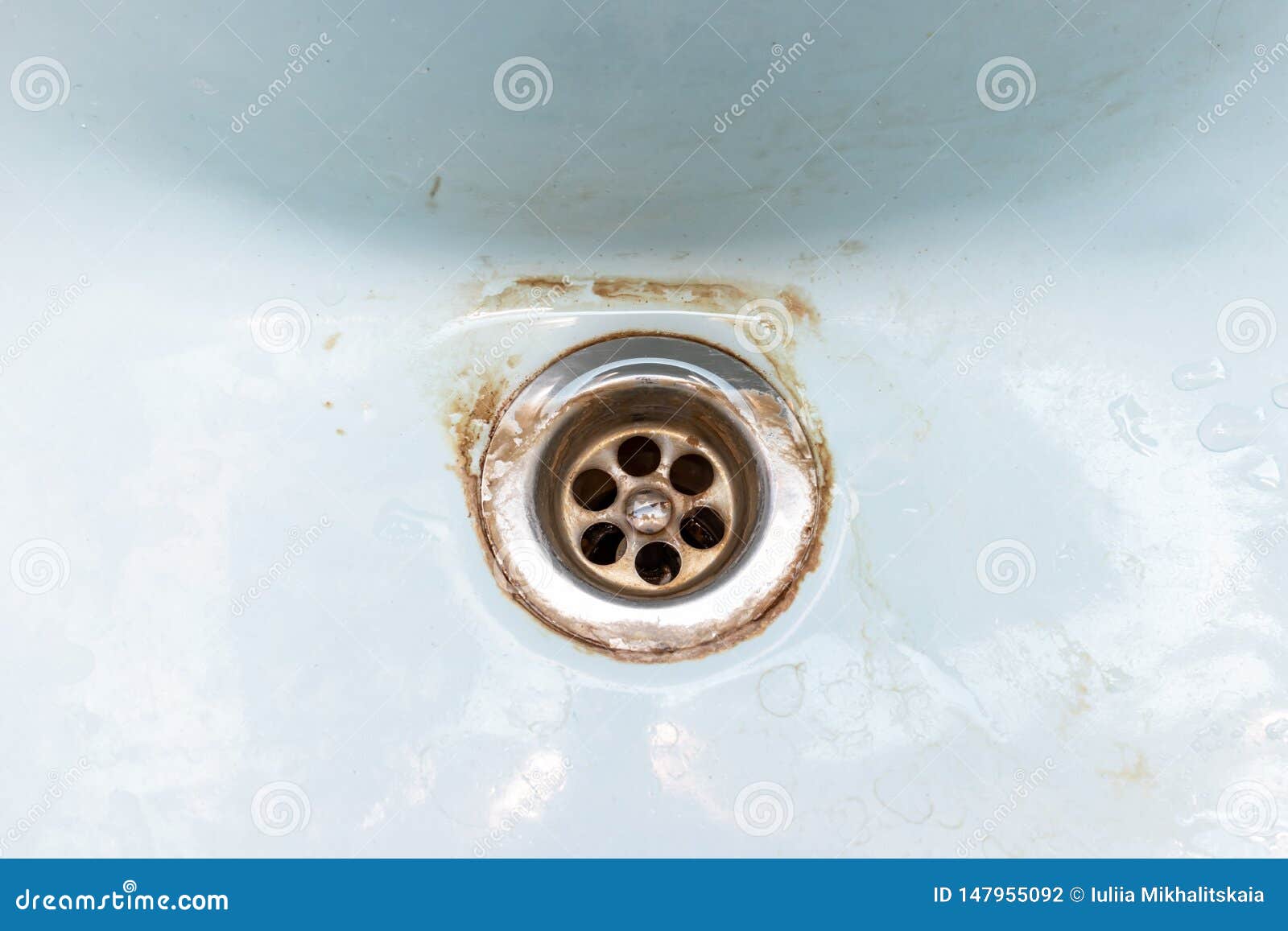 dirty sink drain mesh, hole with limescale or lime scale and rust on it, dirty rusty bathroom washbowl