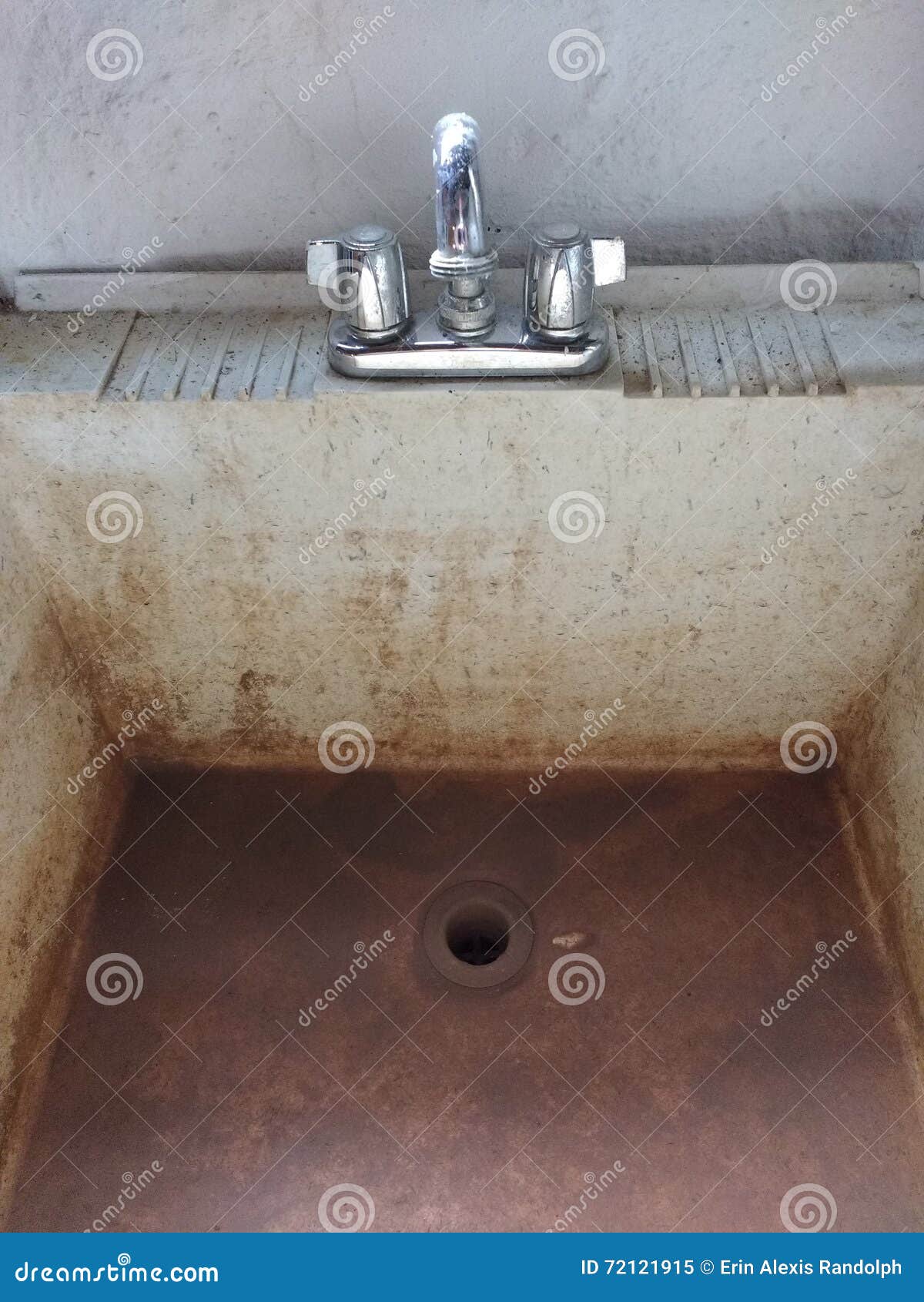 Dirty Slop Sink With Shiny Polished Chrome Faucet Stock Image