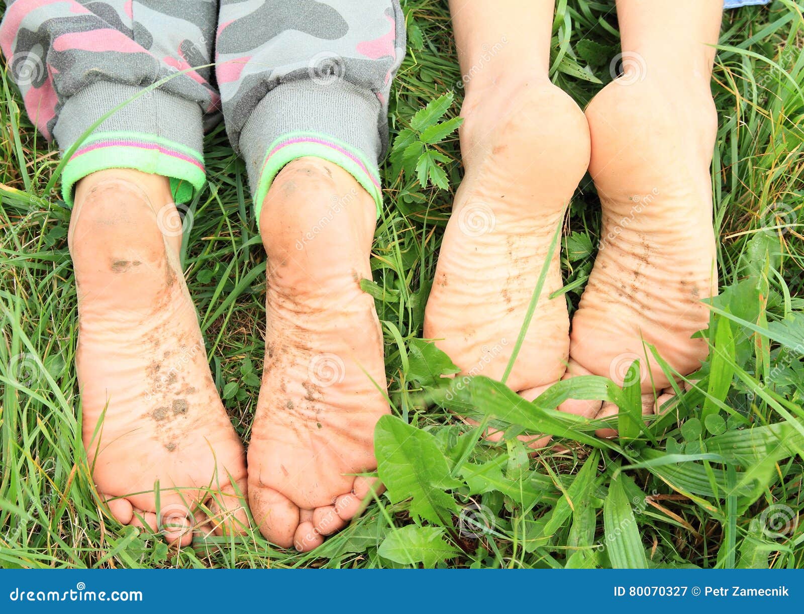 dirty soles of bare feet