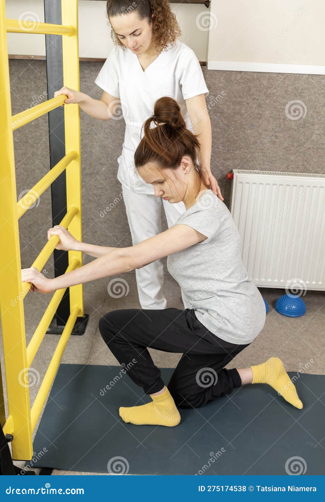 disabled child with physician does physical exercises in gym. kid with special needs