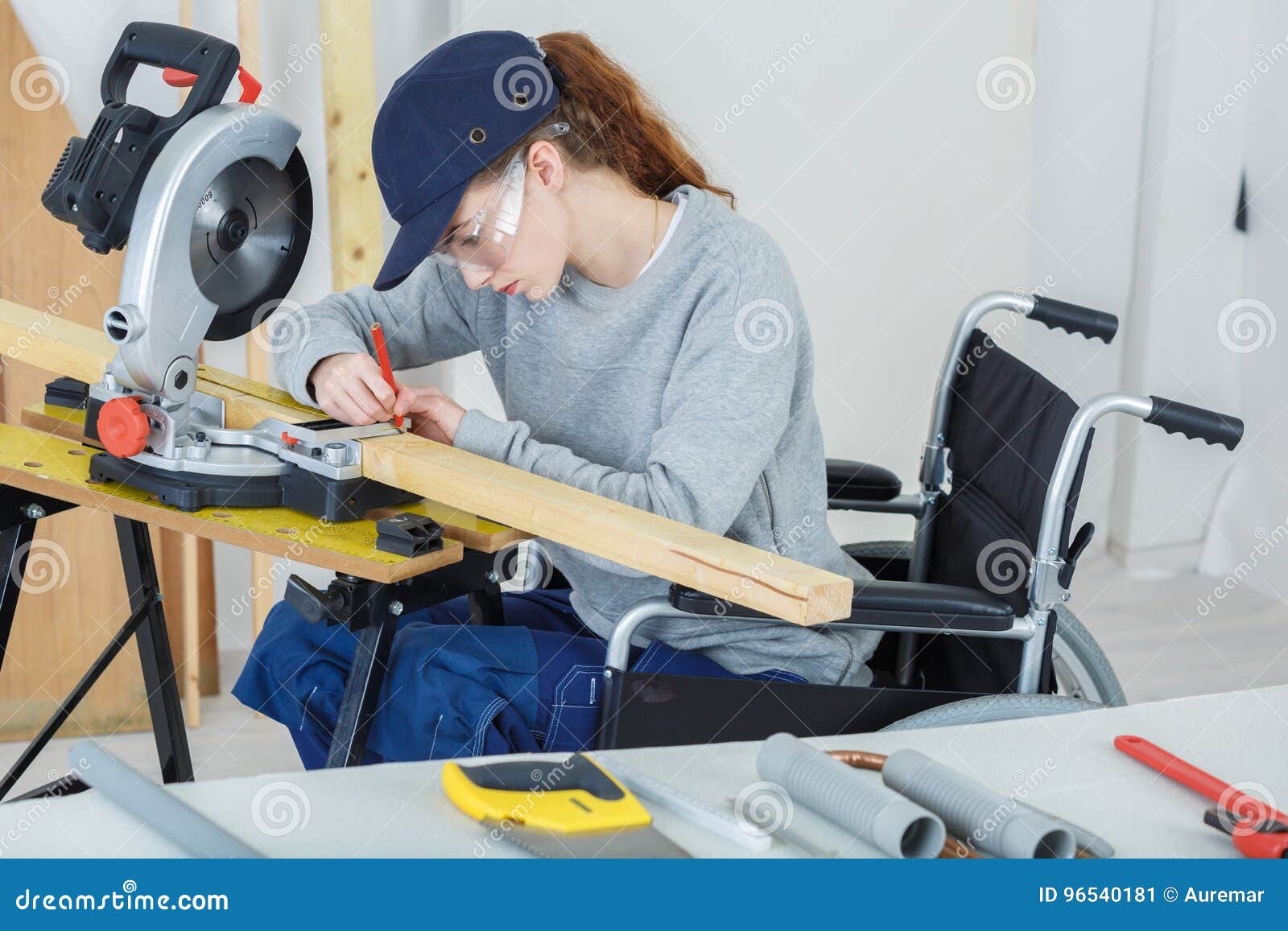 disabled female worker in wheelchair in carpenters workshop