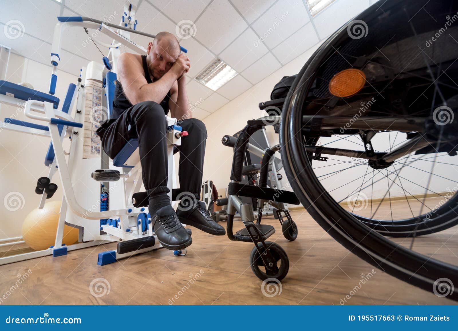 Disabled Man Doing Strength Exercises Separate from the Wheelchair