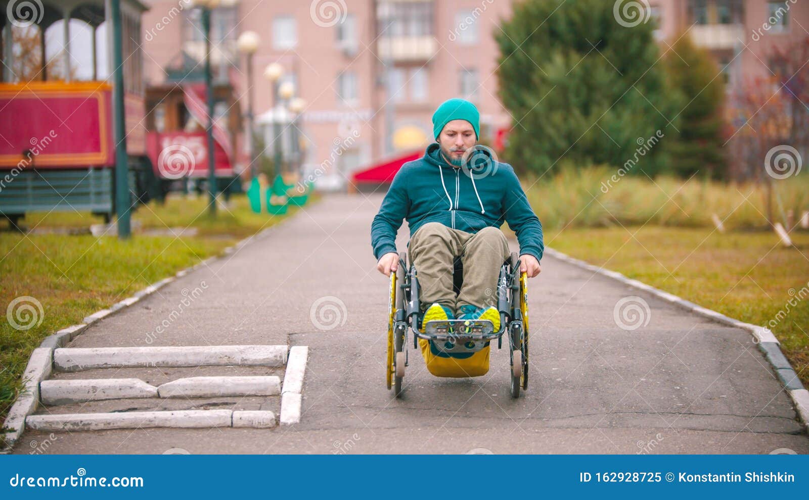 Disabled Man in Wheelchair Going Down the Ramp Outdoors Stock Image