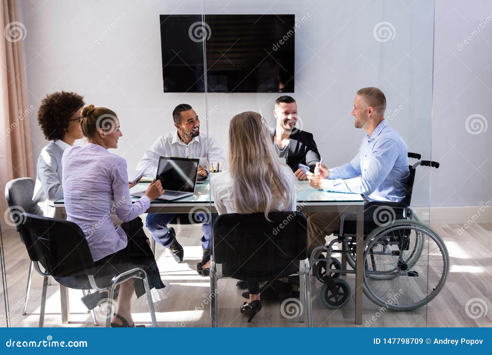 disabled manager sitting with his colleagues